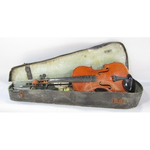 1496 - An old violin with no labels, in need of restoration, and an un named bow, in a distressed carry cas... 