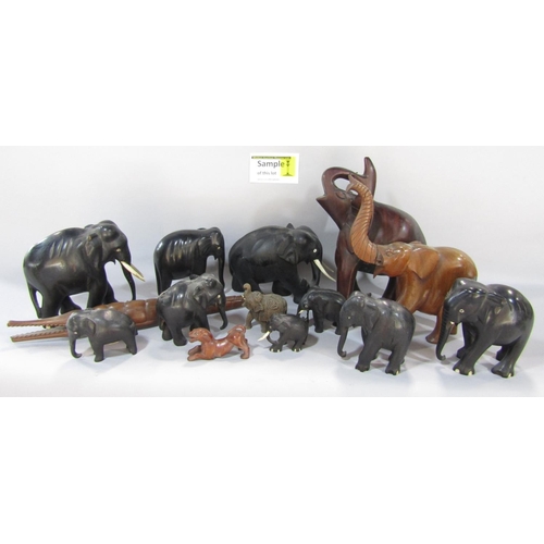 1499 - A small collection of ebony elephants of various sizes, other wooden elephants and a crocodile.