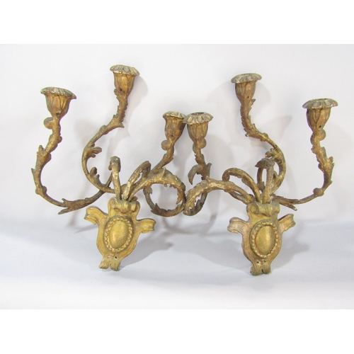 1500 - A pair of 19th century gilt gesso and iron constructed wall candle sconces, in a distressed state an... 