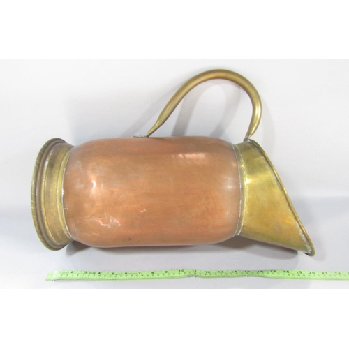 1508 - A 19th century brass and copper pitcher with a brass loop handle, 50cm high.