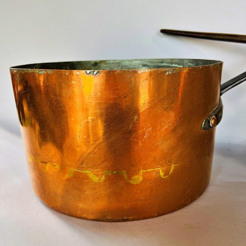 1510 - Three 19th century copper saucepans with cast iron handles and with old repairs, 31cm diam, 28.5cm d... 