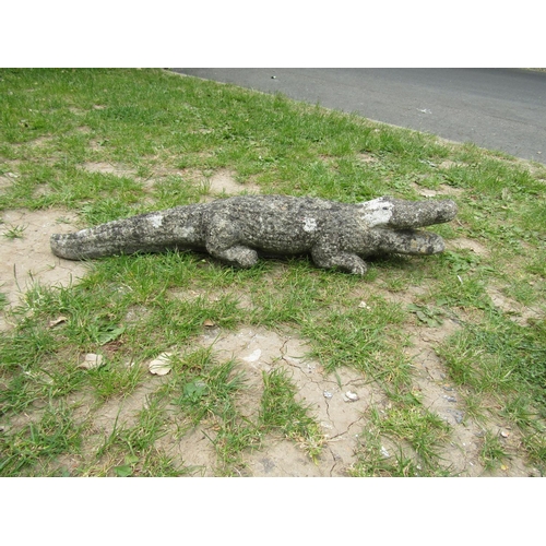 2003 - A weathered cast composition stone garden ornament in the form of an alligator 80 cm long approximat... 