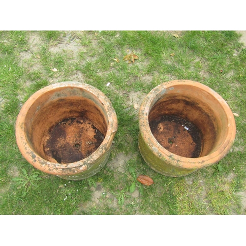 2004 - A pair of weathered squat cylindrical terracotta planters with repeating tree and rolling landscape ... 