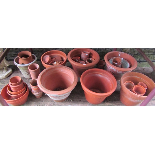 2008 - A quantity of terracotta flower pots of varying size and design, some with incised detail, the large... 