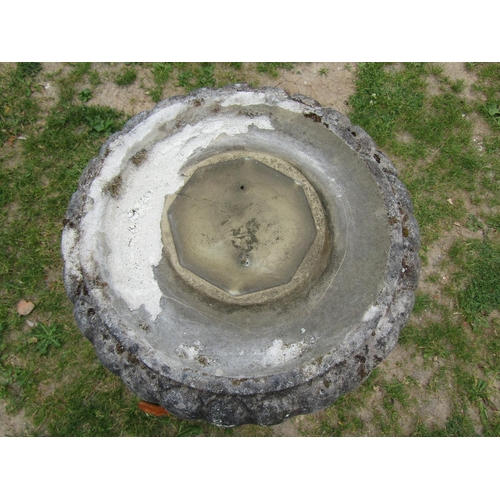 2014 - A weathered cast composition stone three sectional bird bath with circular top raised on a baluster ... 