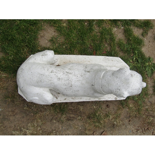 2029 - A painted cast composition stone garden/pier ornament in the form of a recumbent greyhound/whippet s... 