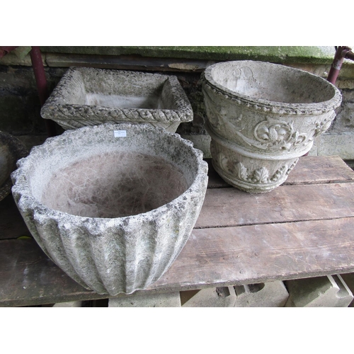 2031 - Three weathered cast composition stone garden planters of varying size and design, one example in th... 