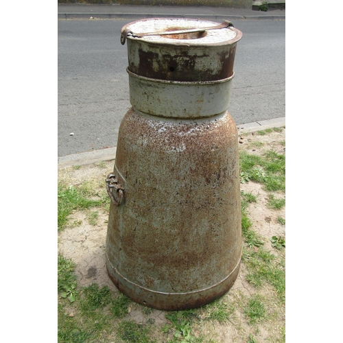 2034 - A vintage heavy gauge cast alloy milk churn of tapered form complete with cap, 75 cm high