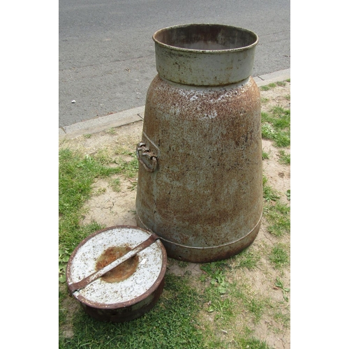 2034 - A vintage heavy gauge cast alloy milk churn of tapered form complete with cap, 75 cm high