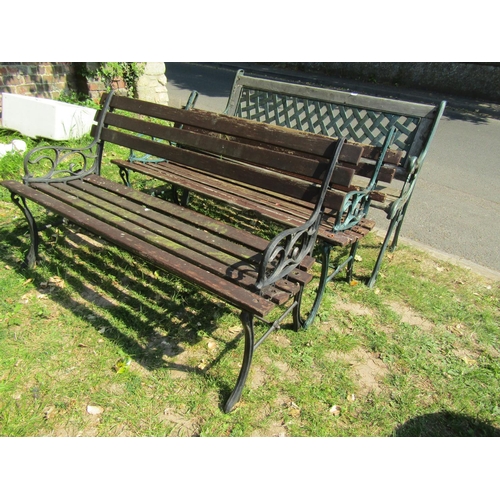 2044 - A two seat garden bench with weathered wooden slatted seat, cast lattice panelled back and scrolled ... 