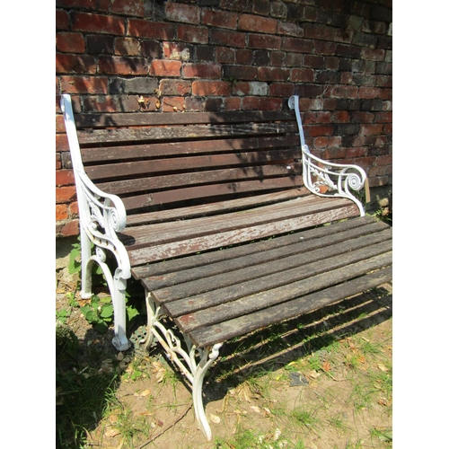 2045 - A two seat garden bench with weathered timber lathes raised on a pair of decorative painted cast all... 