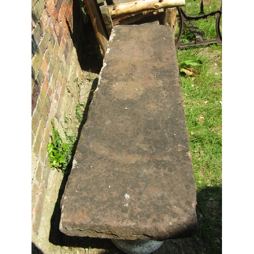 2048 - A three sectional garden bench with rectangular thick natural stone top raised on a pair of cast com... 