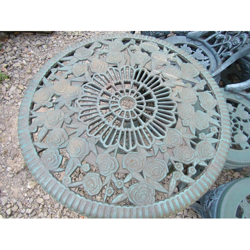 2049 - A modern moulded plastic to simulate metal circular garden table with rosebud detail, 68 cm diameter... 