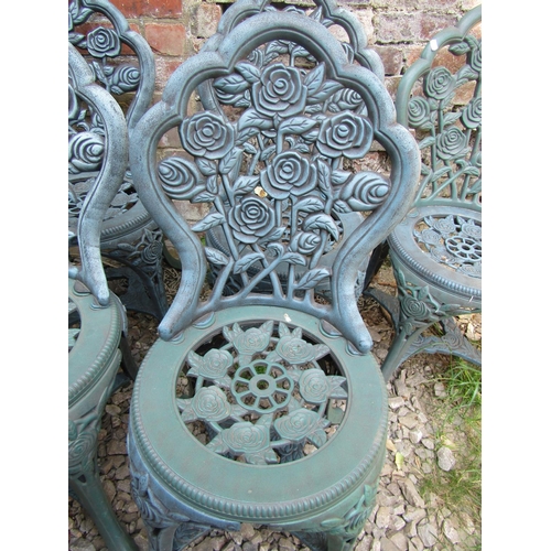 2049 - A modern moulded plastic to simulate metal circular garden table with rosebud detail, 68 cm diameter... 