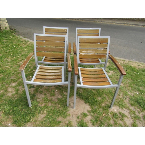 2063 - A set of four weathered contemporary garden terrace chairs capable to stack