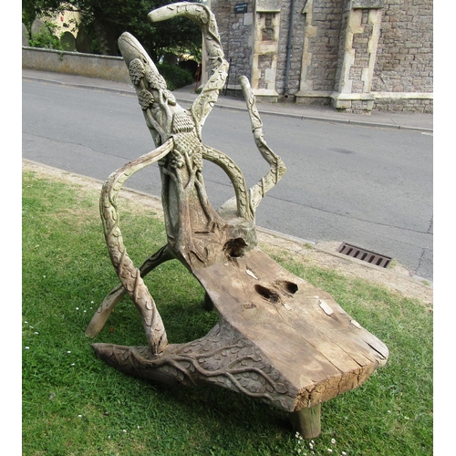 2066 - A large weathered rustic sculptural tree root chair with carved trailing vine, tree and bird detail,... 