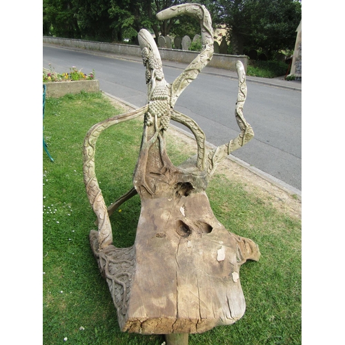 2066 - A large weathered rustic sculptural tree root chair with carved trailing vine, tree and bird detail,... 