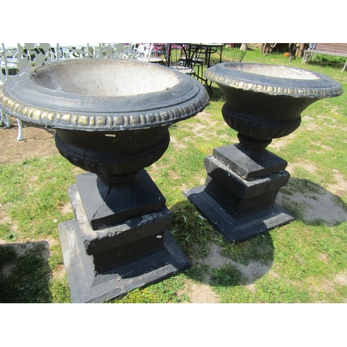 2069 - A pair of painted and weathered cast composition stone garden urns, the circular lobbed bowls with f... 