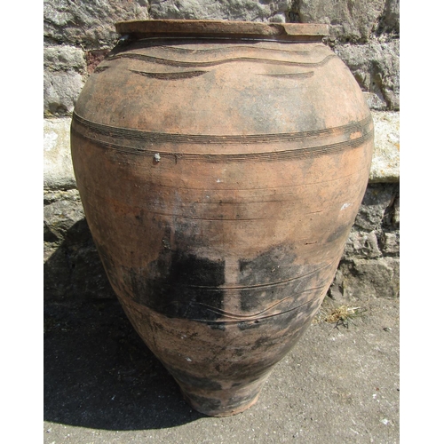 2088 - An old terracotta jar with simple incised detail, 62 cm high