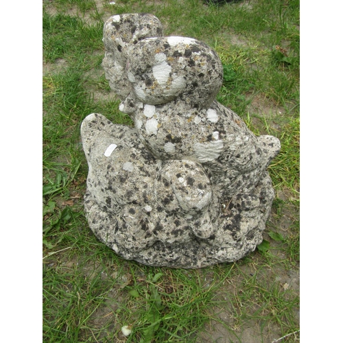 2093 - A well weathered cast composition stone garden ornament in the form of a family of ducks beside a tr... 