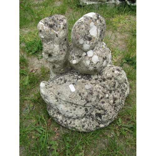 2093 - A well weathered cast composition stone garden ornament in the form of a family of ducks beside a tr... 