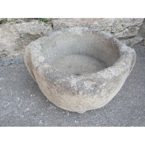 2098 - An antique carved natural stone mortar of circular form with later drilled drainage hole, 34 cm diam... 