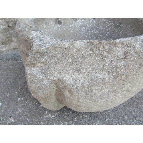 2098 - An antique carved natural stone mortar of circular form with later drilled drainage hole, 34 cm diam... 