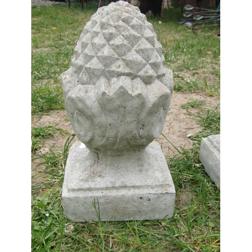 2100 - A pair of small weathered cast composition stone pineapple finials raised on square bases, 33 cm hig... 