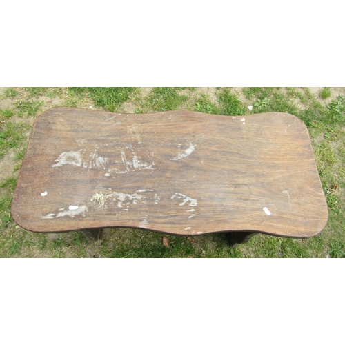 2120 - A small rustic hardwood occasional table with shaped outline and pegged stretcher 92 cm long x 42 cm... 