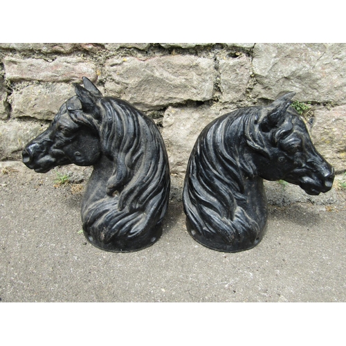 2139 - A pair of small good quality heavy gauge cast iron horses head finials, 27 cm high