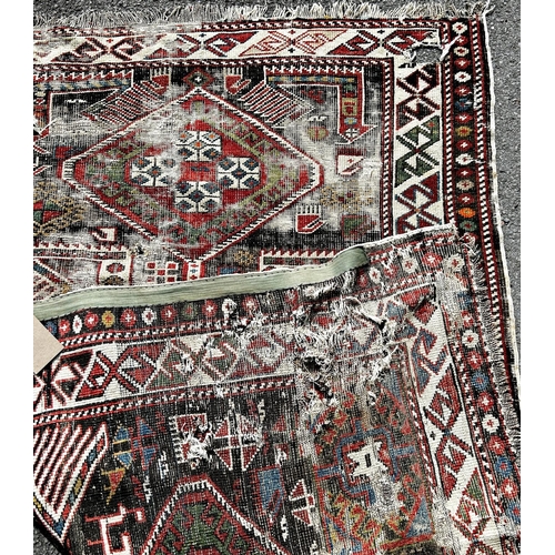 1587 - A Caucasian Kazak old rug, with three hooked medallions, many holes and very worn, 163cm x 110cm app... 