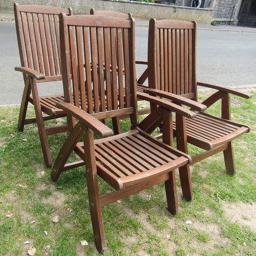 2052 - A set of four stained folding softwood garden armchairs with slatted seats and backs, labelled Gold ... 