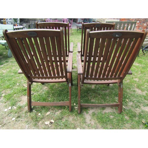 2052 - A set of four stained folding softwood garden armchairs with slatted seats and backs, labelled Gold ... 