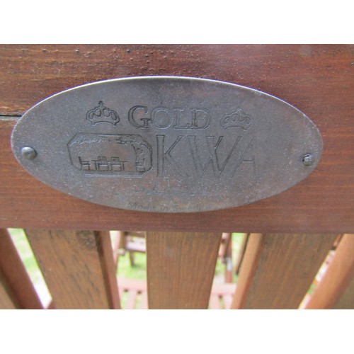 2052 - A set of four stained folding softwood garden armchairs with slatted seats and backs, labelled Gold ... 