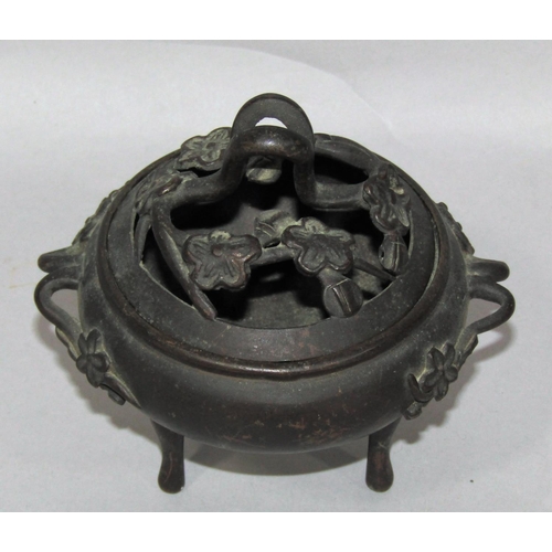 1518 - A small bronze koro with prunus flower cover and handles raised on three slender supports, 13cm x 11... 