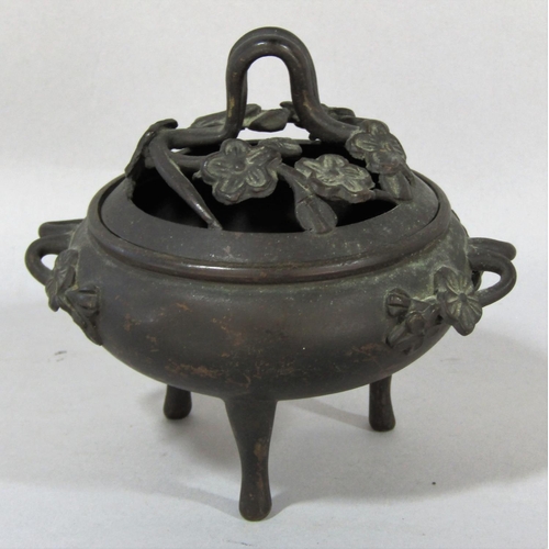 1518 - A small bronze koro with prunus flower cover and handles raised on three slender supports, 13cm x 11... 