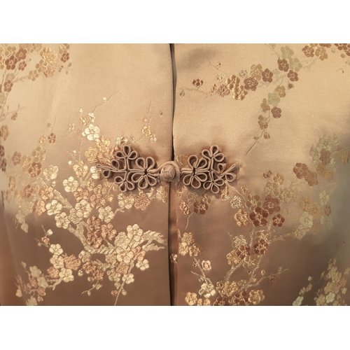 1548 - Vintage kimono in gold patterned silk with frog fasteners and quilted mandarin collar and cuffs. Bac... 