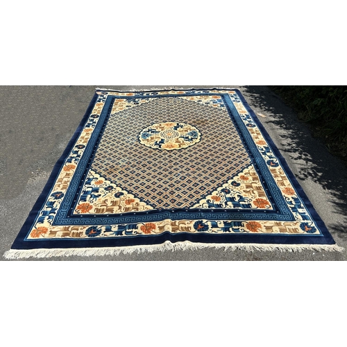 1591 - A Chinese wool carpet with a central circular medallion amongst a trellis of flowers and a floral bo... 