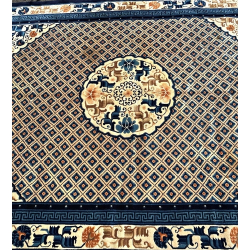 1591 - A Chinese wool carpet with a central circular medallion amongst a trellis of flowers and a floral bo... 