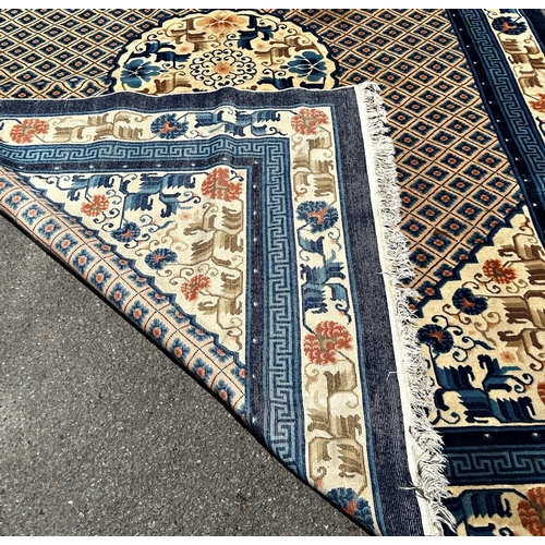 1591 - A Chinese wool carpet with a central circular medallion amongst a trellis of flowers and a floral bo... 