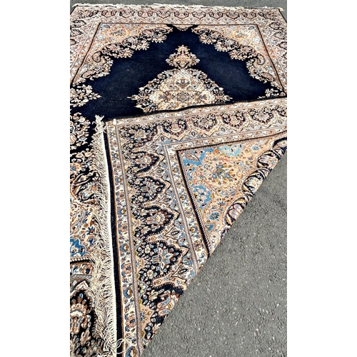 1597 - A large Persian Kerman type carpet with an extended lozenge medallion on a predominantly blue ground... 