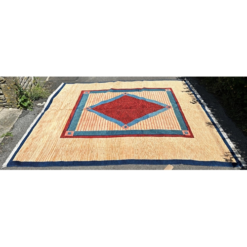 1598 - A modern (new) Turkish wool carpet with a red diamond centre with a turquoise and red border and out... 