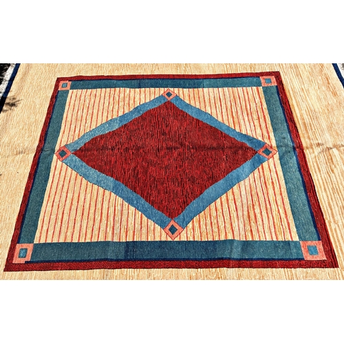 1598 - A modern (new) Turkish wool carpet with a red diamond centre with a turquoise and red border and out... 