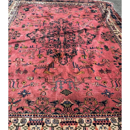 1600 - A large country house Malayer design carpet with a stylised floral centre with further stylised flow... 