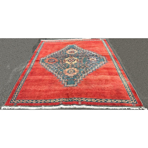 1601 - A modern Kazak design carpet in wool with a central stepped medallion decorated with flowers on a pr... 