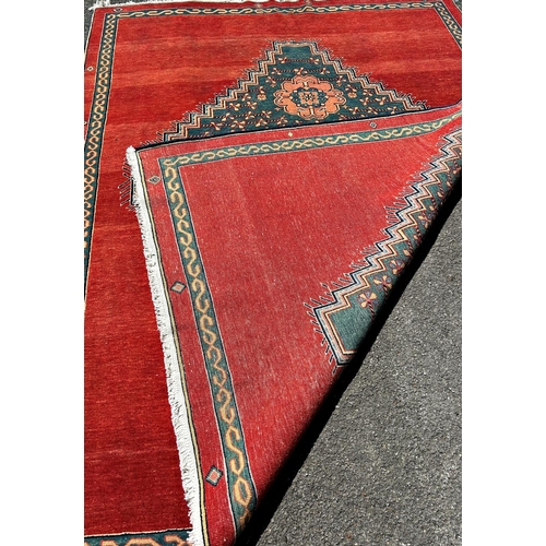 1601 - A modern Kazak design carpet in wool with a central stepped medallion decorated with flowers on a pr... 