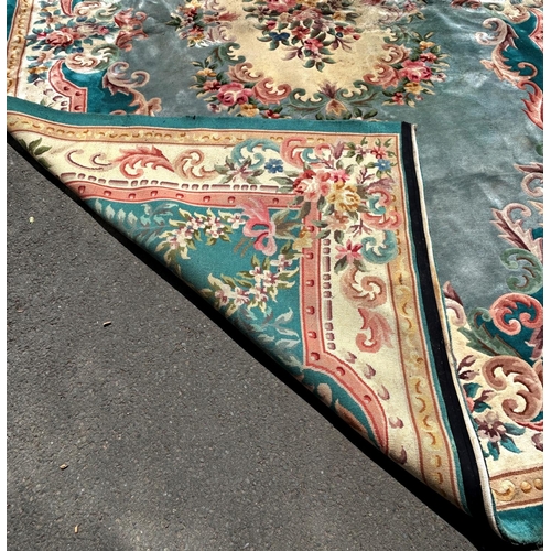 1612 - A large wool 18th century Aubusson style carpet with a central cluster of flowers on a green ground ... 