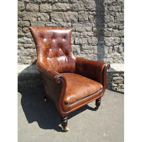 2745 - A William IV mahogany library chair with moulded outline and mid-tan upholstery