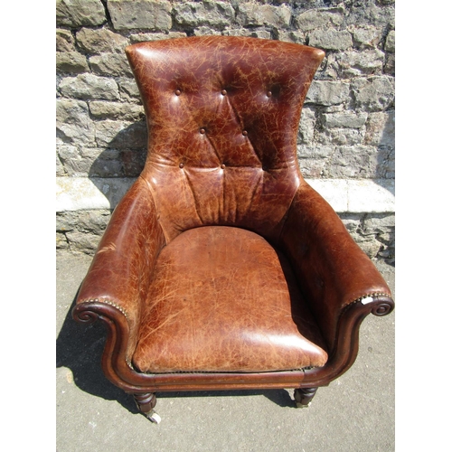 2745 - A William IV mahogany library chair with moulded outline and mid-tan upholstery