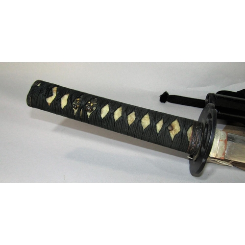 1485A - A Japanese sword with black lacquered scabbard with paperwork